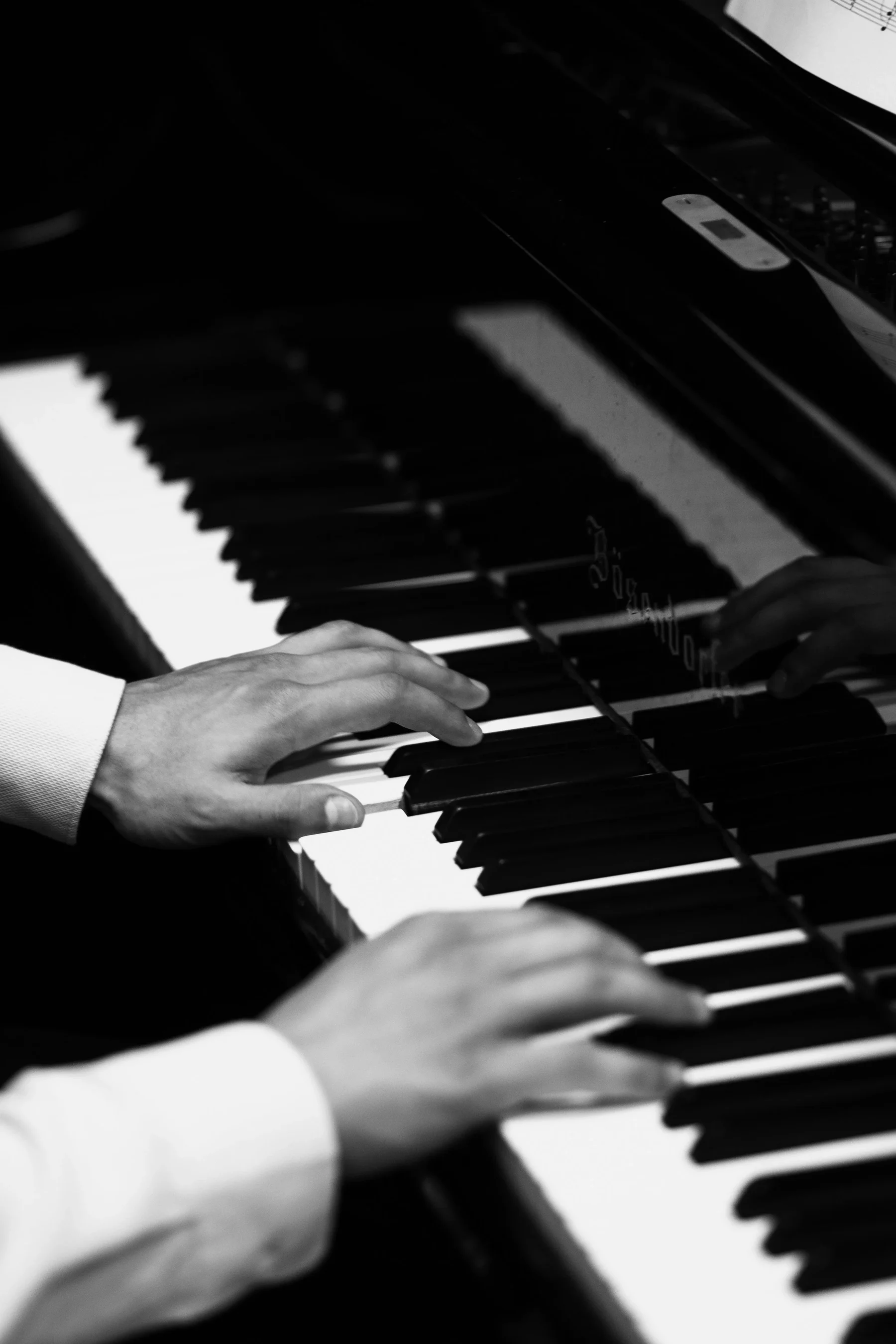 Hands playing the piano